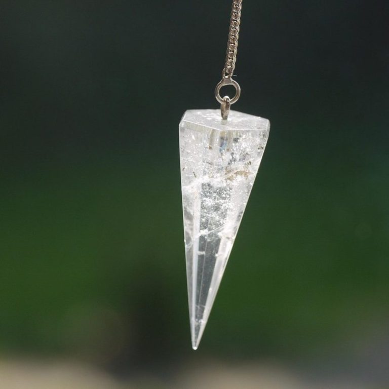A quartz pendulum is suspended in the air.